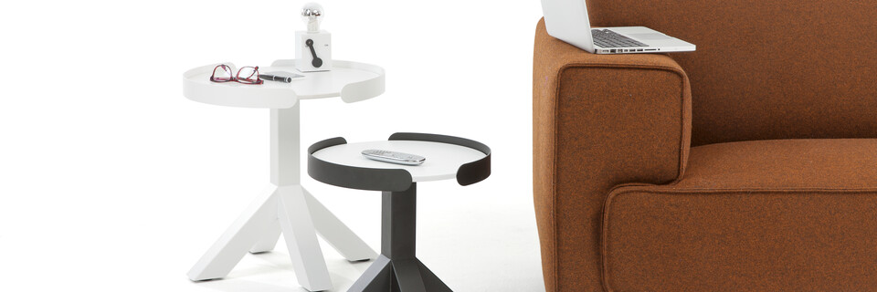 Gispen Dukdalf round small and large side tables in white and black with Switch table lamp next to brown sofa front view