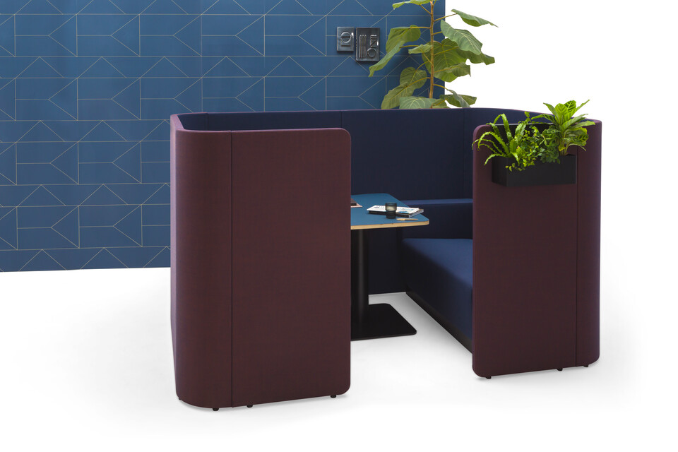 Gispen HUGG Duo couch XL upholstered in blue and black table and planters and blue backpanel front view