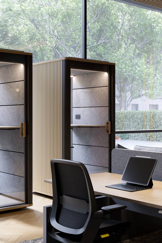 Royal Ahrend Cerene Calls office pods in grey with wooden slats sides  side by side and black Swaye stand aid in office space
