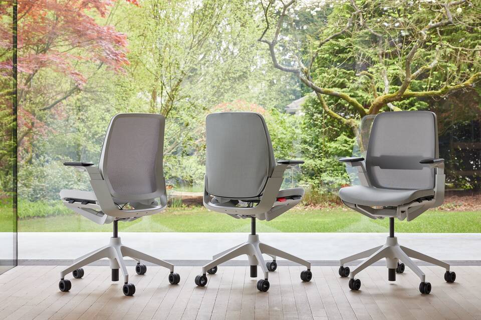 Ahrend Remode office chairs in grey in different configurations with trees in background right rear front right view