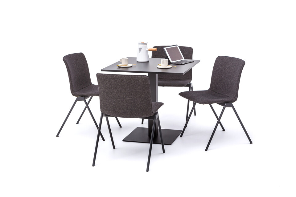 Gispen KOLM Column square conference table with black frame and black square 100 tabletop and 4 black Nomi Design chairs styled front right view