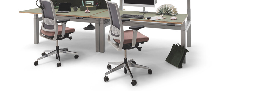 Gispen TMNL dual workstation 3 stage sit stand in light grey with green tops and green screen with Zinn office chairs front right view