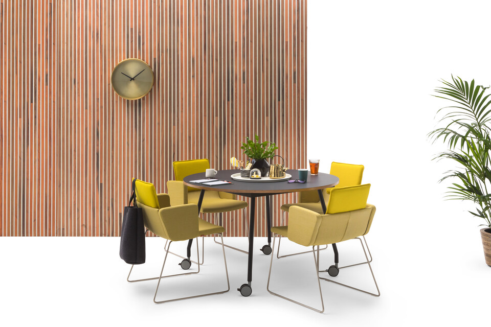 Gispen TEAM Project wheels conference table with black legs and frame and tabletop with yellow Triennial Project chairs and scrapwood backpanel front view