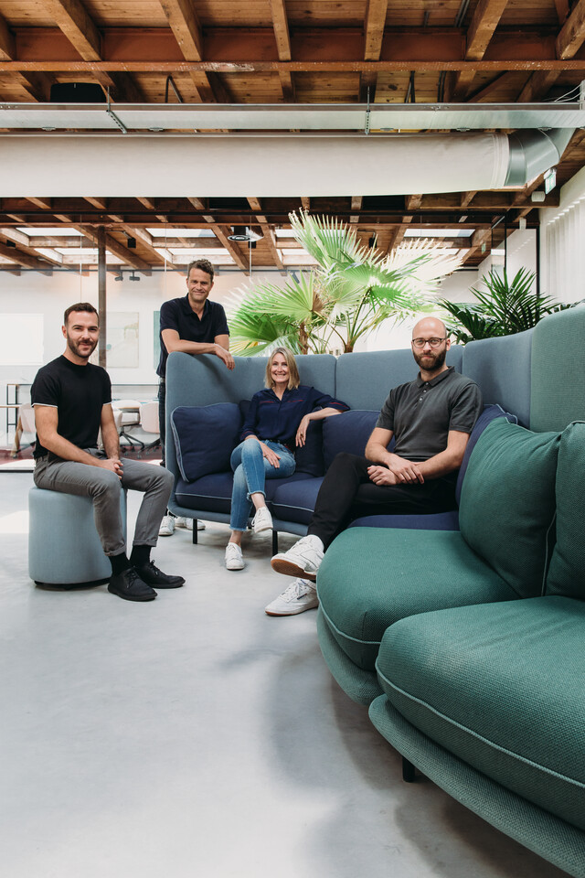 Royal Ahrend Embrace sofa upholstered in green and blue with designers at HofmanDujardin office in Diemen EB004