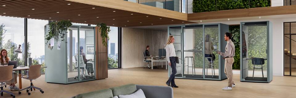 Ahrend Qabin Chat Focus and Chat Connect high and Call space in space in ice blue with models in a vitalising workspace interior view