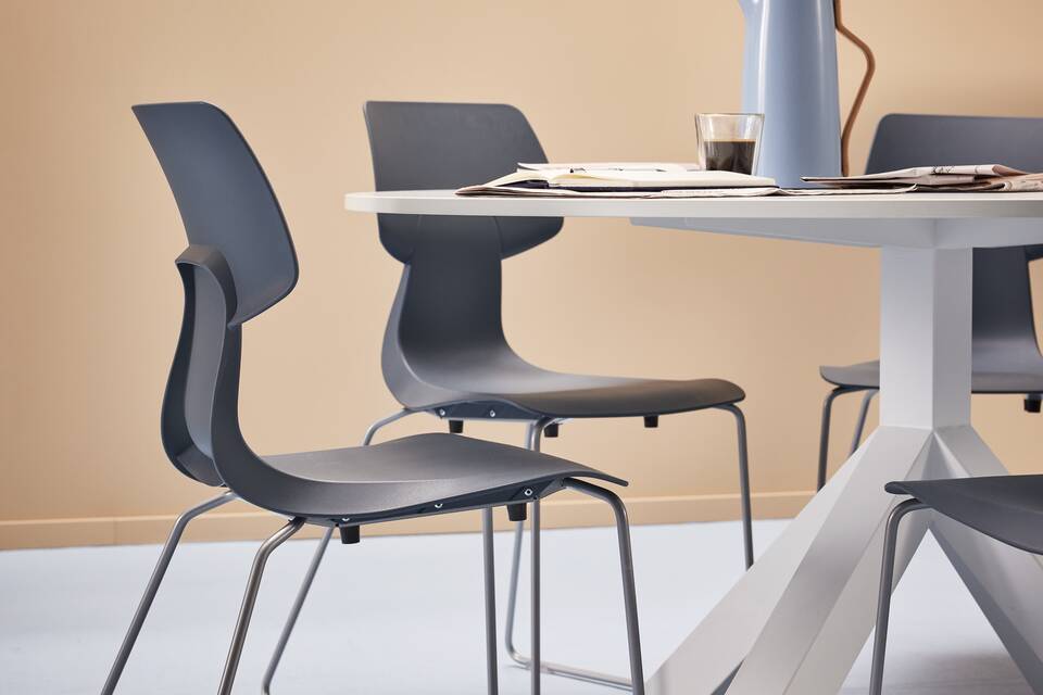 Gispen WIZZ wireframe in blue chairs with white Dukdalf table in a blue beige higher education setting left rear view