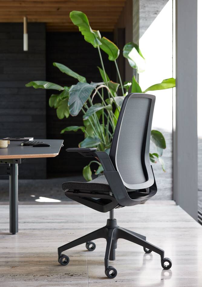 Ahrend Remode office chair in black with Modea dual workstation in a work setting right rear view