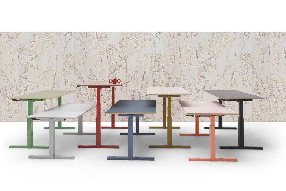 Gispen TMNL 7 single workstations in different colours in front of marble backpanel with red dombo cup right side view