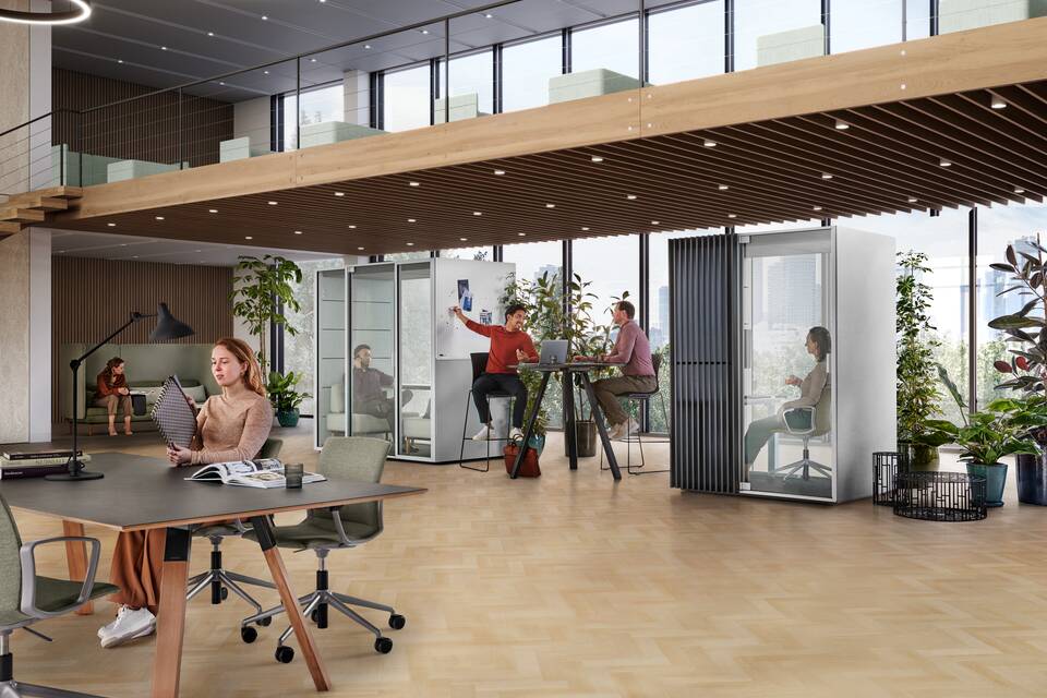 Qabin Chat Lounge, Qabin Focus low, Aero, Well, Charge Ahrend Qabin Chat Lounge and Work space in space in grey with models talking and listening in a vitalising workspace interior view