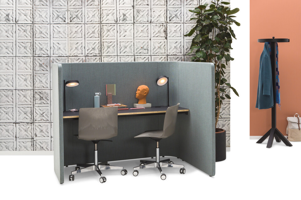 Gispen HUGG Solo desk XL upholstered in light blue with matt black top and 2 Nomi Work plus chairs with Dukdalf coat rack with recycled shells styled front left view