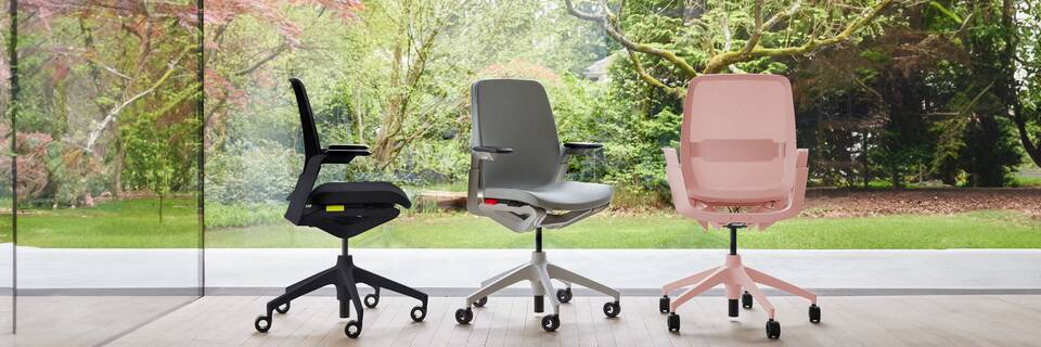 Remode Ahrend Remode office chairs in black grey and pink in different configurations with trees in background header front left side and rear view