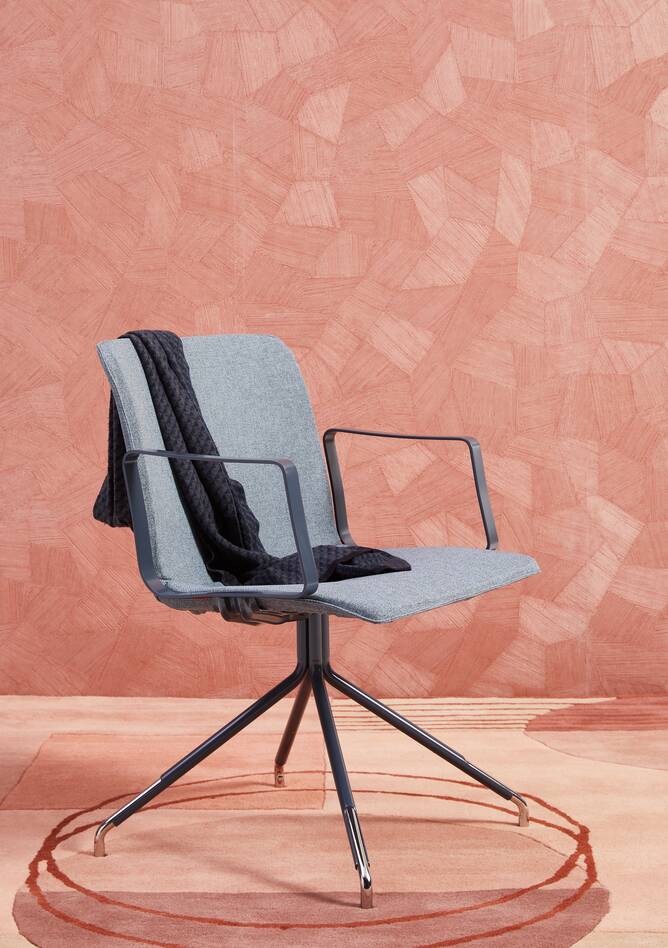 Gispen NOMI Work chair in blue with armrests and blue upholstered cover styled on carpet with backpanel front left view