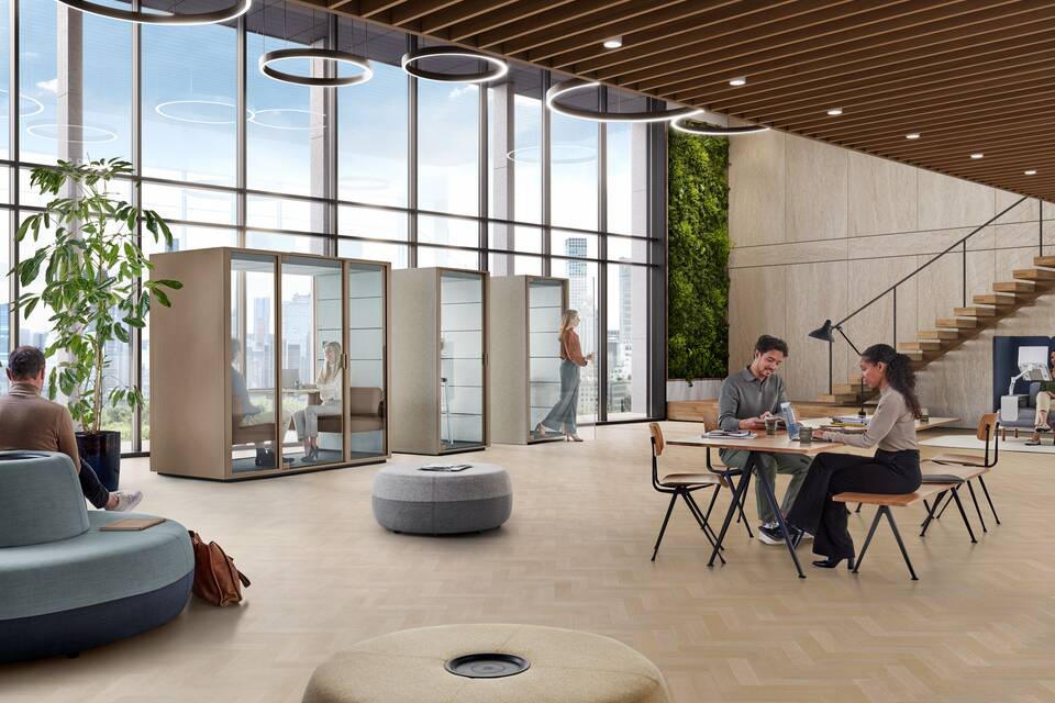 Ahrend Qabin Chat Lounge and Calls space in space in clay grey with models reading working in a vitalising workspace interior view