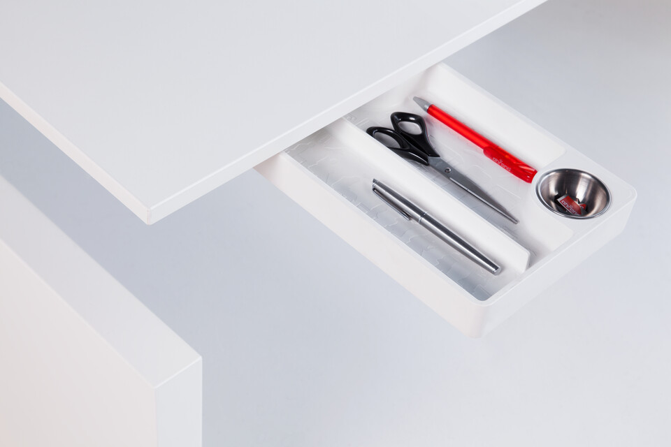 Royal Ahrend Clean desk tray in white fully retracted out from under tabletop filled with utensils front left view