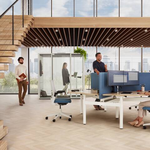 Ahrend Modea sit stand trio workstation in white with oak tabletop and blue S25 screens with standing models in a vitalising workspace interior view