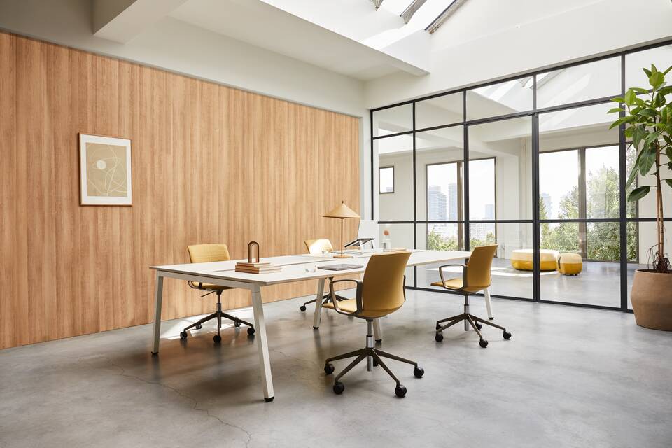Techo Fount bench with white a frame and oak tabletops with yellow upholstered Well chairs styled front left view
