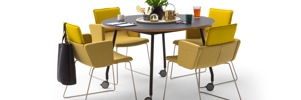 Gispen TEAM Project wheels conference table with black legs and frame and tabletop with yellow Triennial Project chairs styled front view
