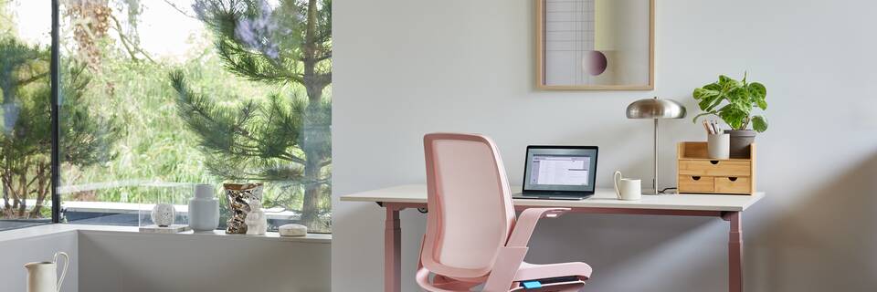 Ahrend Remode office chair in pink  with balance solo workstation in a home setting right rear view