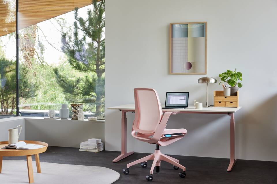 Ahrend Remode office chair in pink  with balance solo workstation in a home setting right rear view