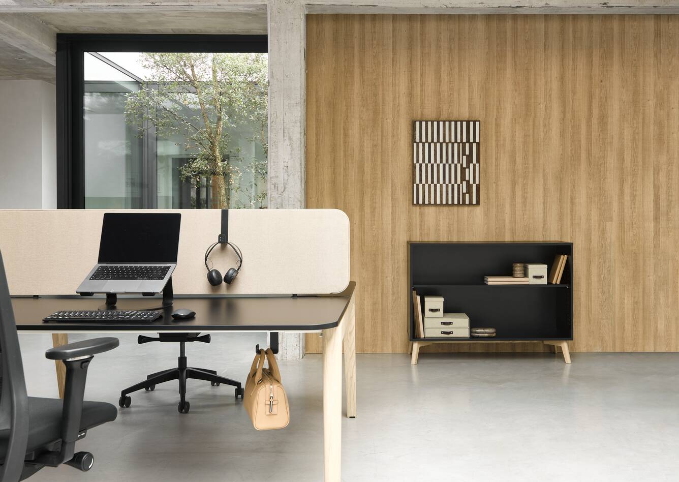 Techo Fount dual workstation with ash legs and black top with beige WF25 screen with black bag hook and bag and black Hyll cabinet on birch legs front view