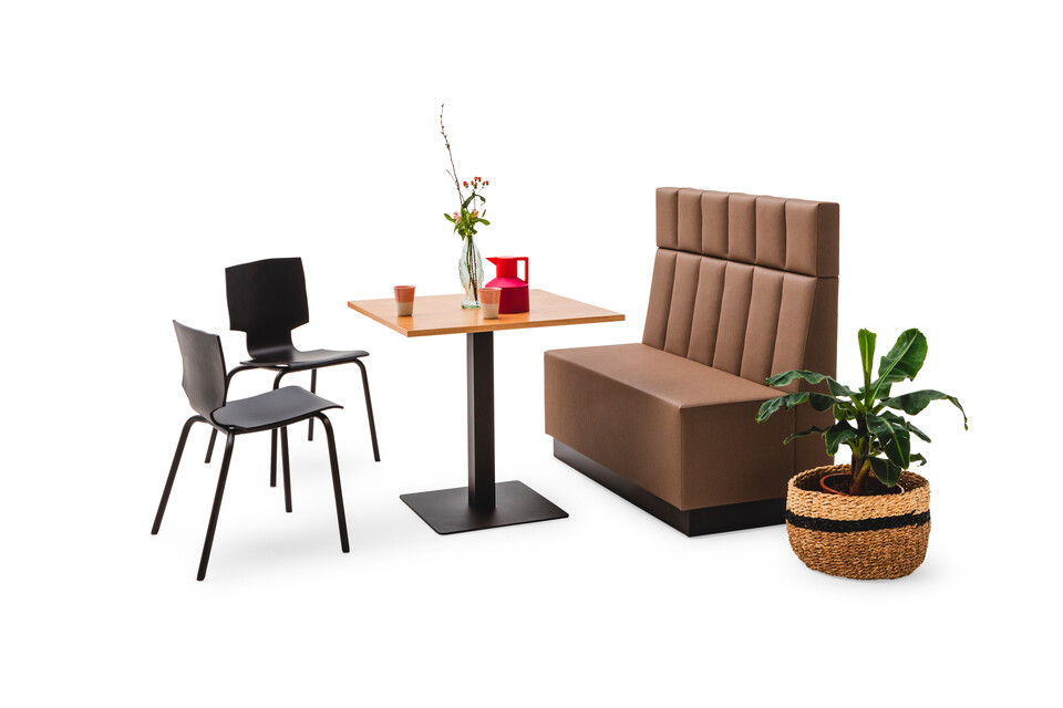 Gispen JUNA Single high trainbench upholstered in brown with black KOLM column table and 2 black More or Less chairs front right view