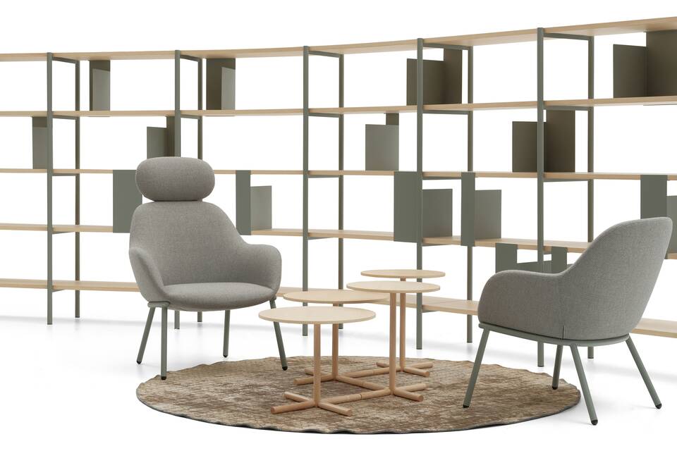 Deberenn Amber armchair with green four leg base and grey upholstered shell with and without headrest in setting with Flow shelving front view