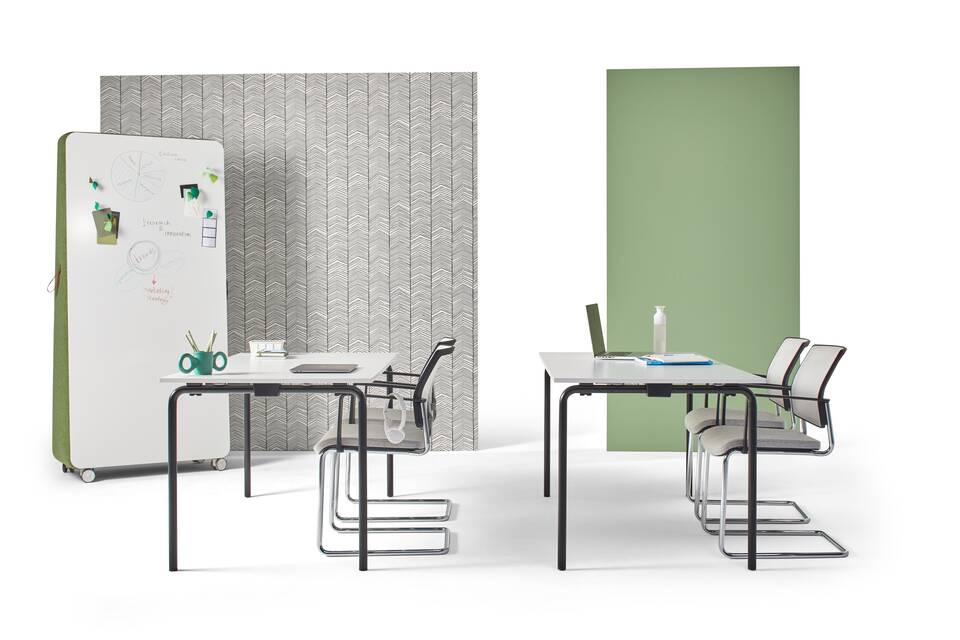 Gispen FLOO foldable tables with black legs and white tabletops in school setup styled with ZINN conference chairs and whiteboard right side view