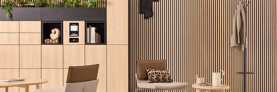 Hyll Smart Locker, Fount, Alva, Triennial Relax Techo Hyll Smart locker in oak with Fount coffee tables with Triennial Relax armchair upholsterd in brown and grey and black Alva coatstand with umbreallaholder styled front view