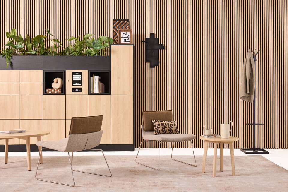 Hyll Smart Locker, Fount, Alva, Triennial Relax Techo Hyll Smart locker in oak with Fount coffee tables with Triennial Relax armchair upholsterd in brown and grey and black Alva coatstand with umbreallaholder styled front view