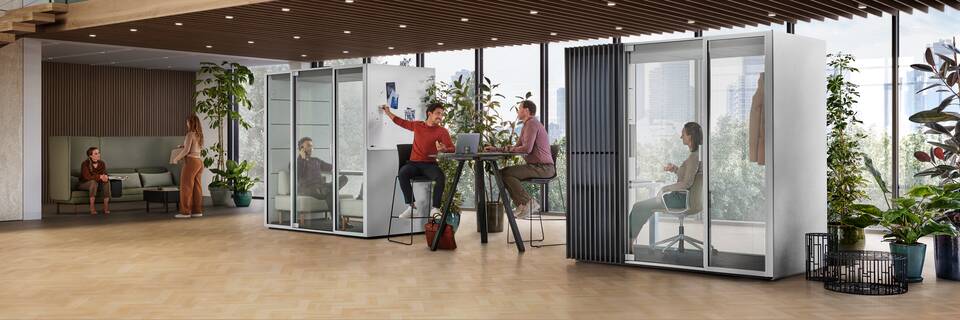 Ahrend Qabin Chat Lounge and Chat Focus low space in space in grey with people talking listening header in a vitalising workspace interior view