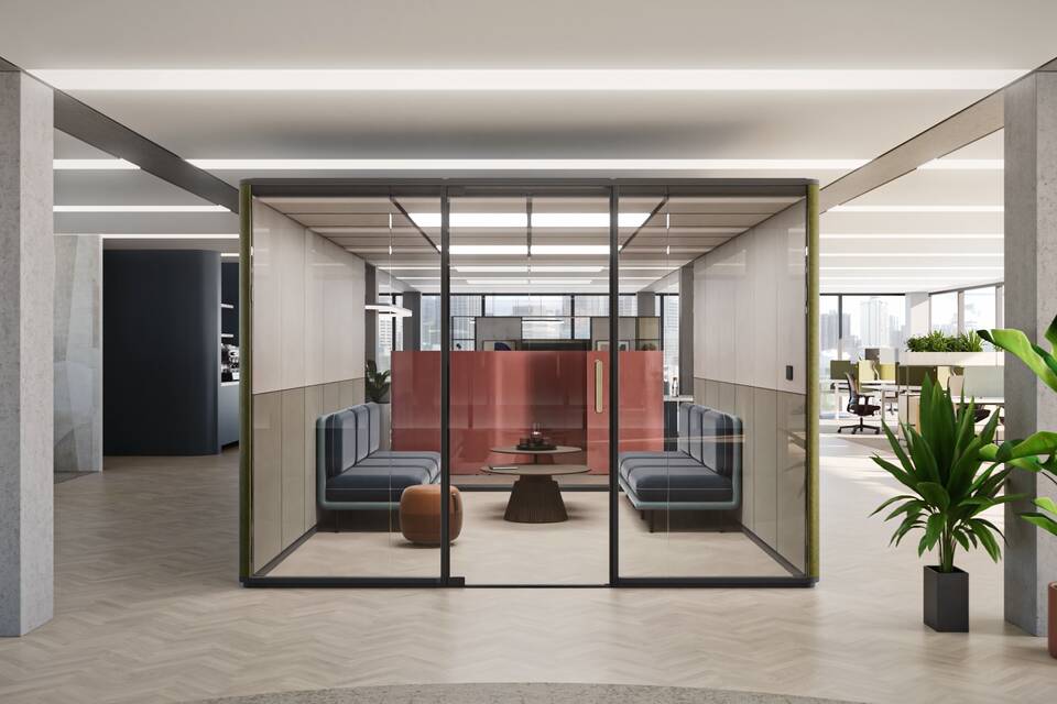 Royal Ahrend Zoniq office pod in anthracie and upholstered in orange with blue Embrace sofa and green Recharge 45 pouf in office setting front view