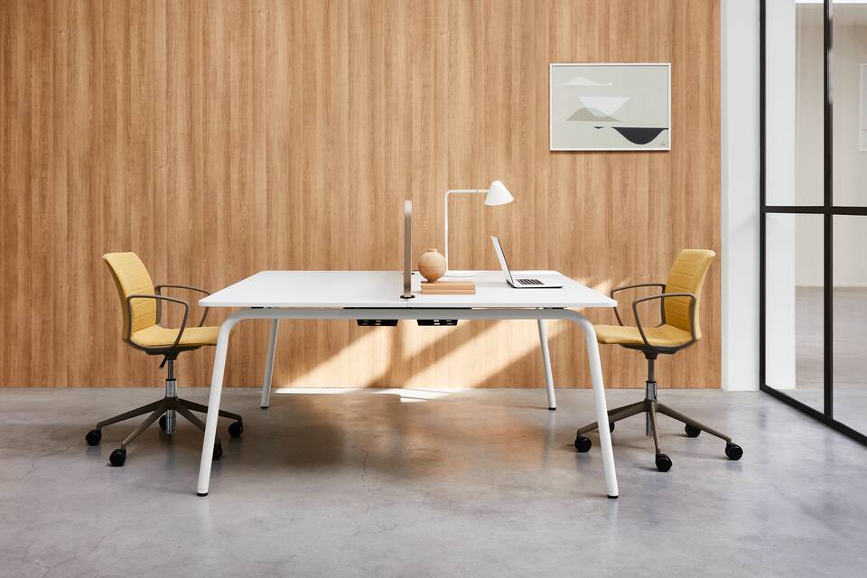 Techo Fount dual workstation with white round frame and white tabletops with yellow upholstered Well chairs styled side view