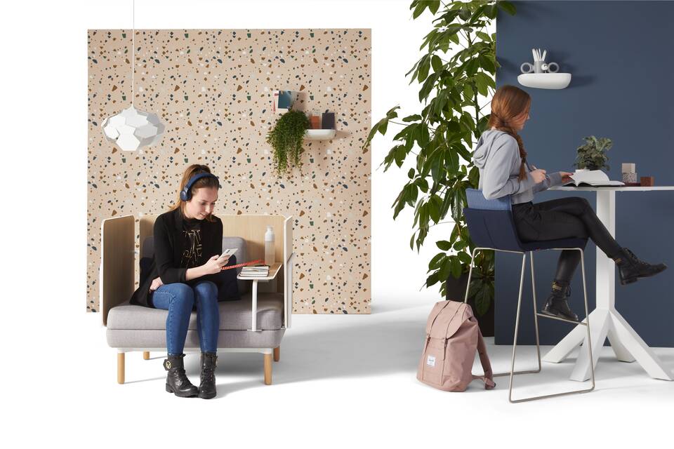 Gispen STEE armchair in white upholstered in grey with white Dukdalf high table and Triennial High 65 upholstered in blue with female models front view