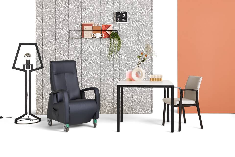 Gispen UT round 4 leg table in black with white tabletop and care armchair styled with backpanels front view