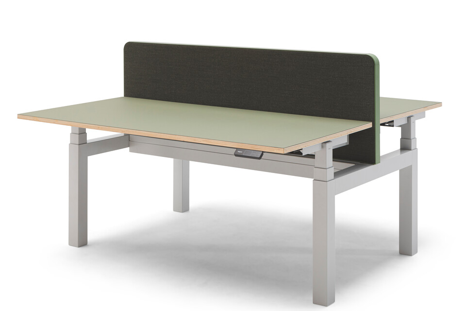 Gispen TMNL dual workstation 3 stage sit stand in light grey with display on the right under green tops and green screen front right view