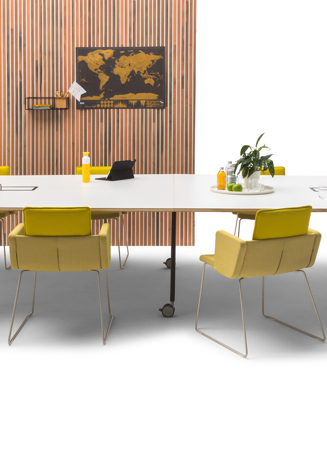 Gispen TEAM Project wheels conference table with black legs and frame with white tabletop with yellow Triennial Project chairs and scrapwood backpanel front view