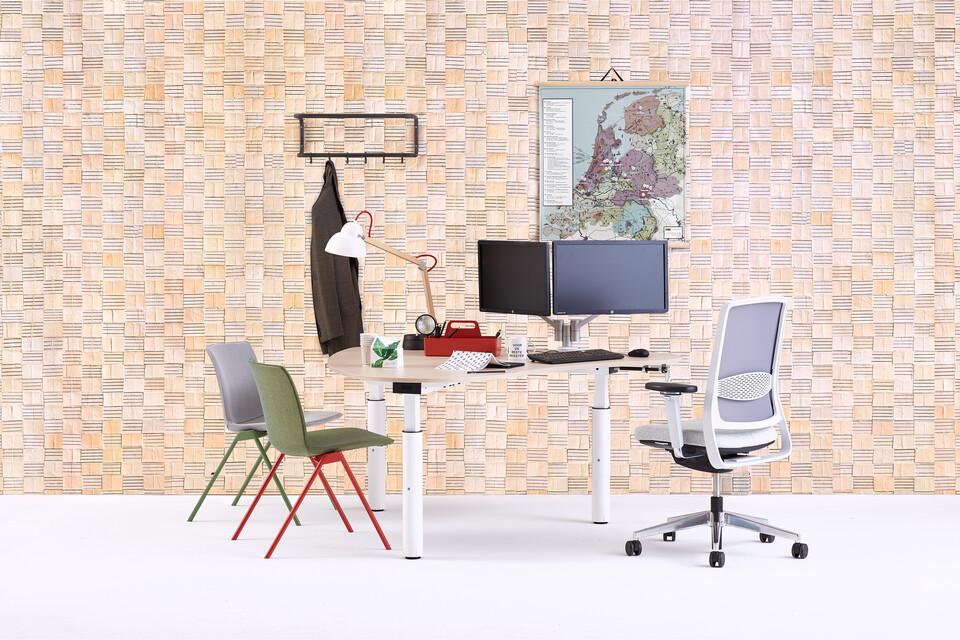 Gispen TM Doc table with white frame and oak tabletop with Zinn office chair and red and green Nomi Design chairs with Mapp of The Netherlands front view