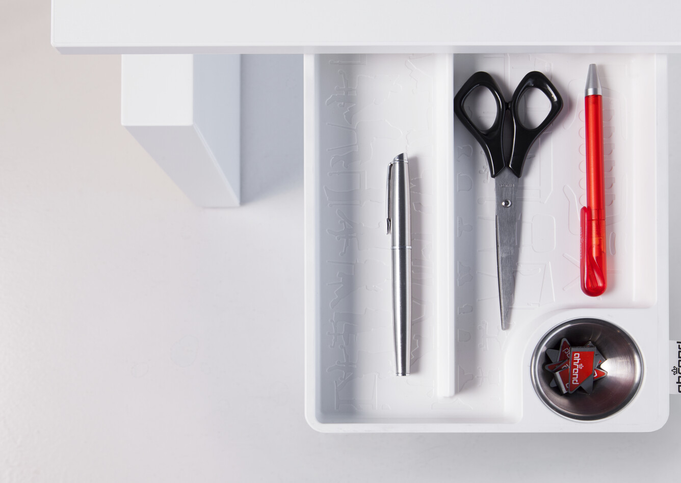 Royal Ahrend Clean desk tray in white fully retracted from under tabletop filled with utensil top view