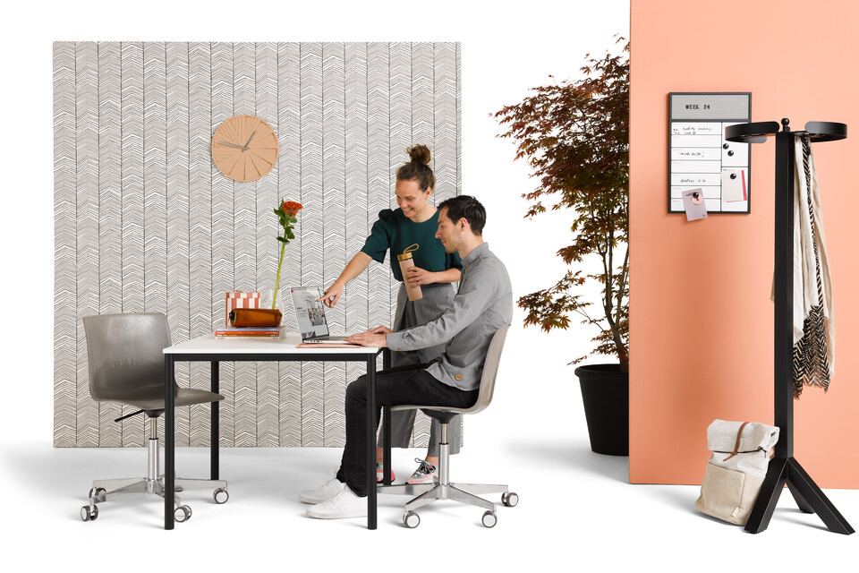 Gispen UT round 4 leg table in black with white tabletop with Nomi Work+ chairs and models styled with backpanels front view