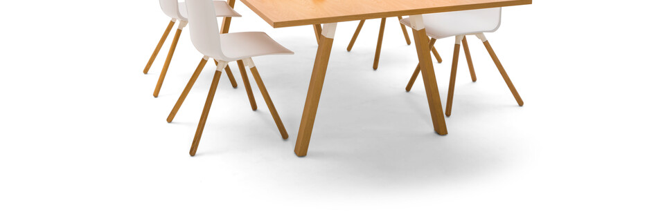 Gispen TEAM Wood rectangle conference table with diagonal oak legs and tabletop with white Nomi Wood chairs with styling front right view