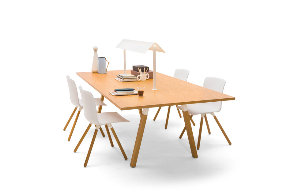 Gispen TEAM Wood rectangle conference table with diagonal oak legs and tabletop with white Nomi Wood chairs with styling front right view