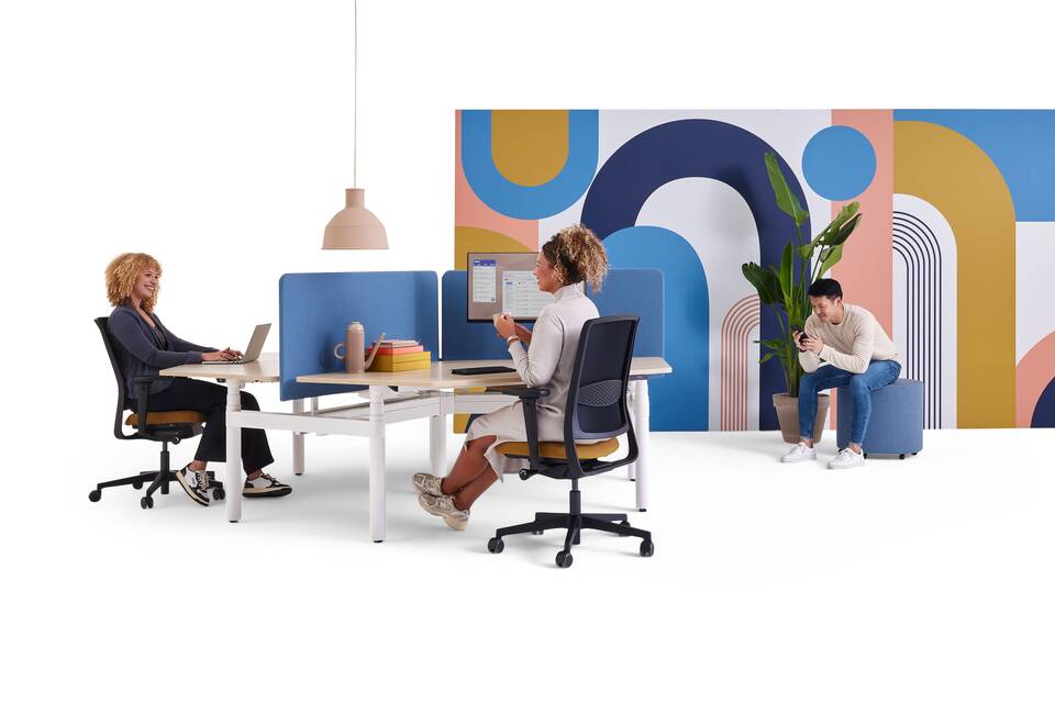 Gispen TMNL Round sit stand trio workstation with oak tabletops and blue S25 screens styled with ZINN office chairs and models front view