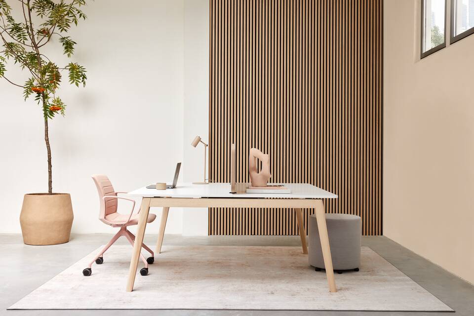Techo Fount dual workstation with oak a frame and white tabletops with brown WF25 screen and pink Well chair with grey Assist pouf styled side view