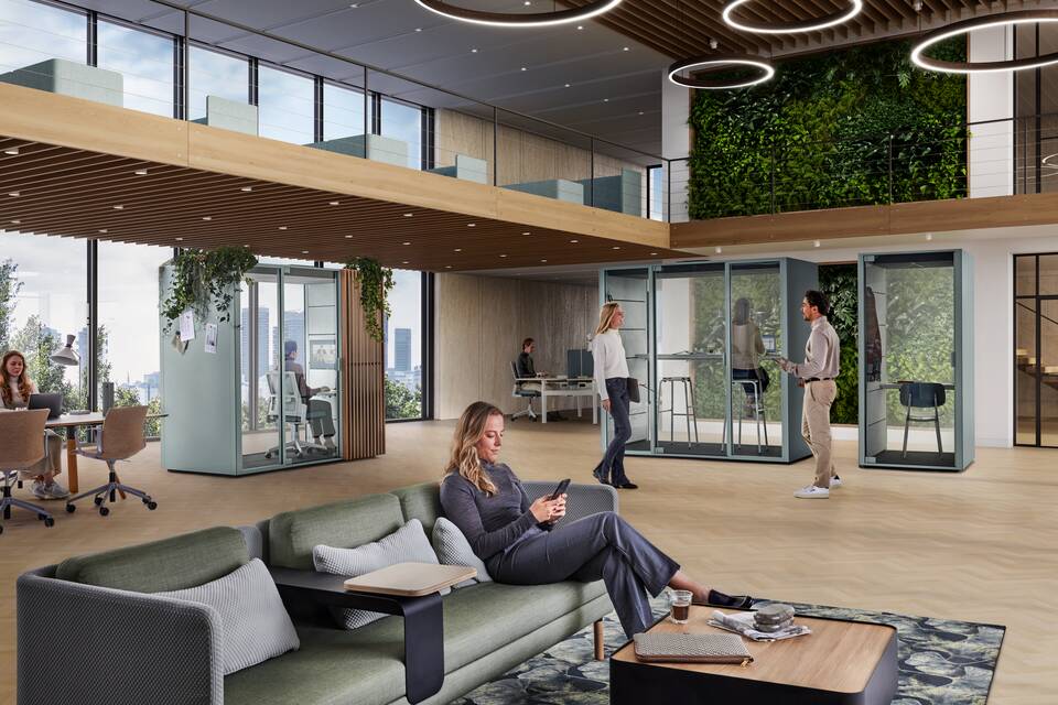 Ahrend Qabin Chat Focus and Chat Connect high and Call space in space in ice blue with models and one on Charge sofa in a vitalising workspace interior view