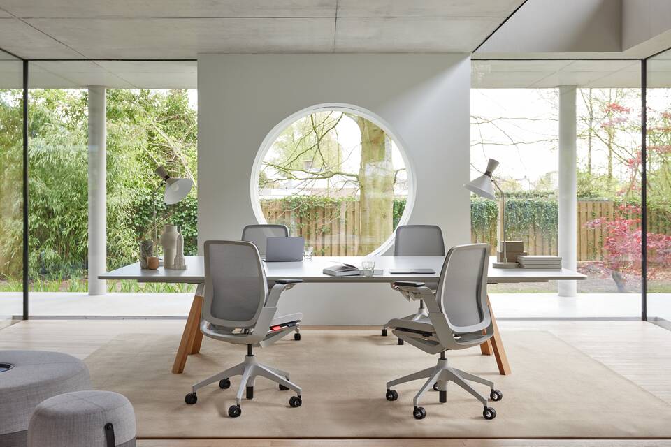 Ahrend Remode office chairs in grey and an Aero bench in a colaborative setting interior view