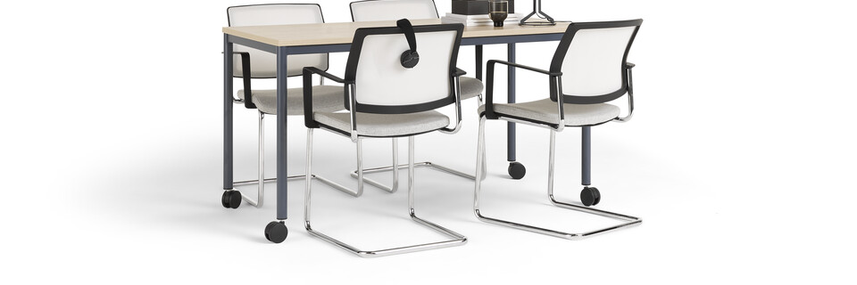 Gispen UT round 4 leg table in blue with oak tabletop on castors and grey ZINN conference chairs styled front left view