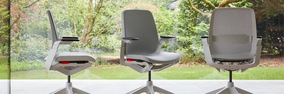 Ahrend Remode office chairs in grey in different configurations with trees in background front left side and rear view