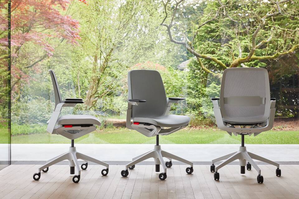 Ahrend Remode office chairs in grey in different configurations with trees in background front left side and rear view