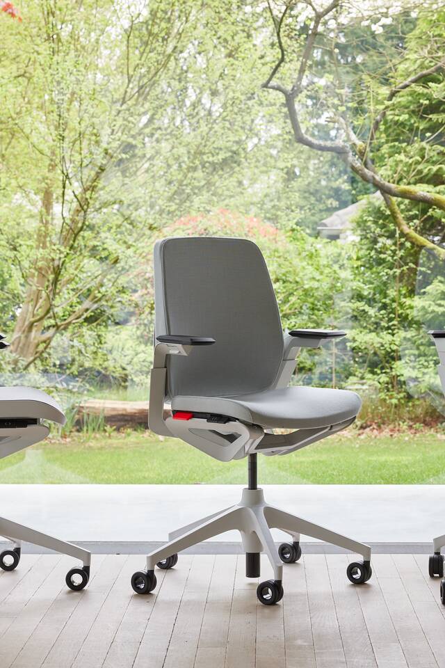 Ahrend Remode office chairs in grey in different configurations with trees in background front left side and rear view