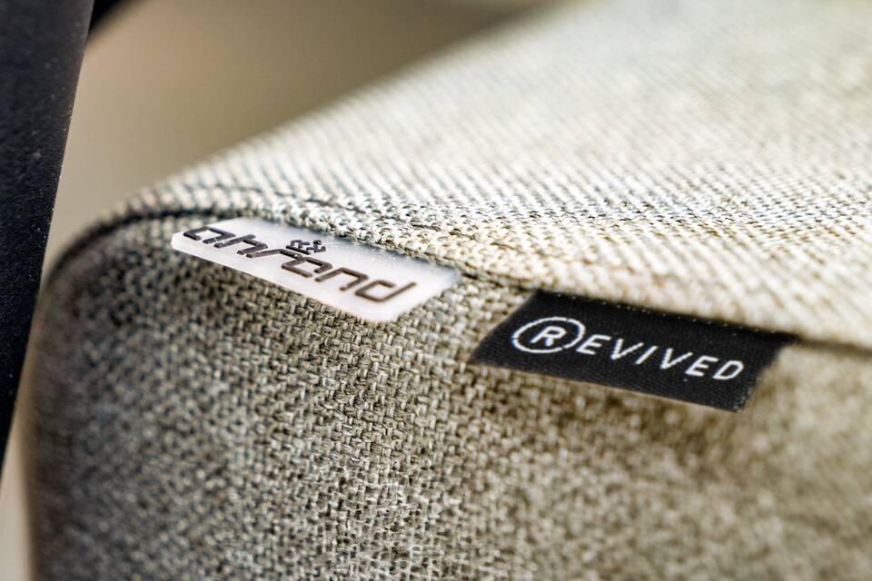 Royal Ahrend 2020 office chair with beige upholstered and Revived label seat front left detail view